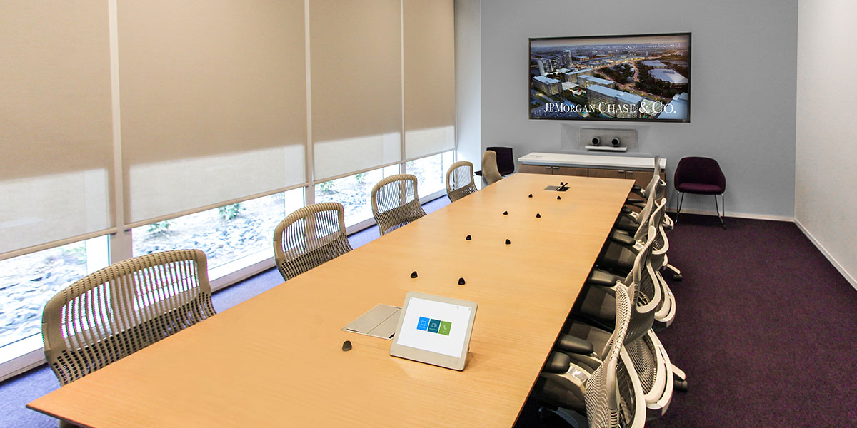 Modern JPMorgan Chase conference room featuring integrated audio-visual technology designed and installed by Ford AV to enhance collaborative workplace communication.