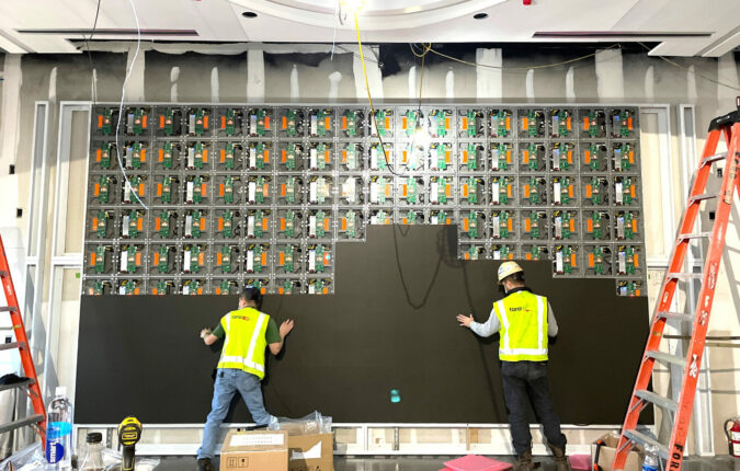 Large digital display wall being installed by Ford AV technicians
